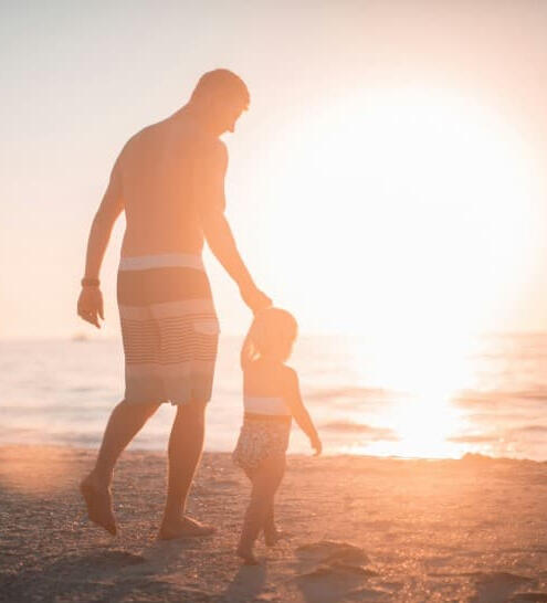 Man and child at the beach. protect your family with life insurance solutions from Call to Freedom